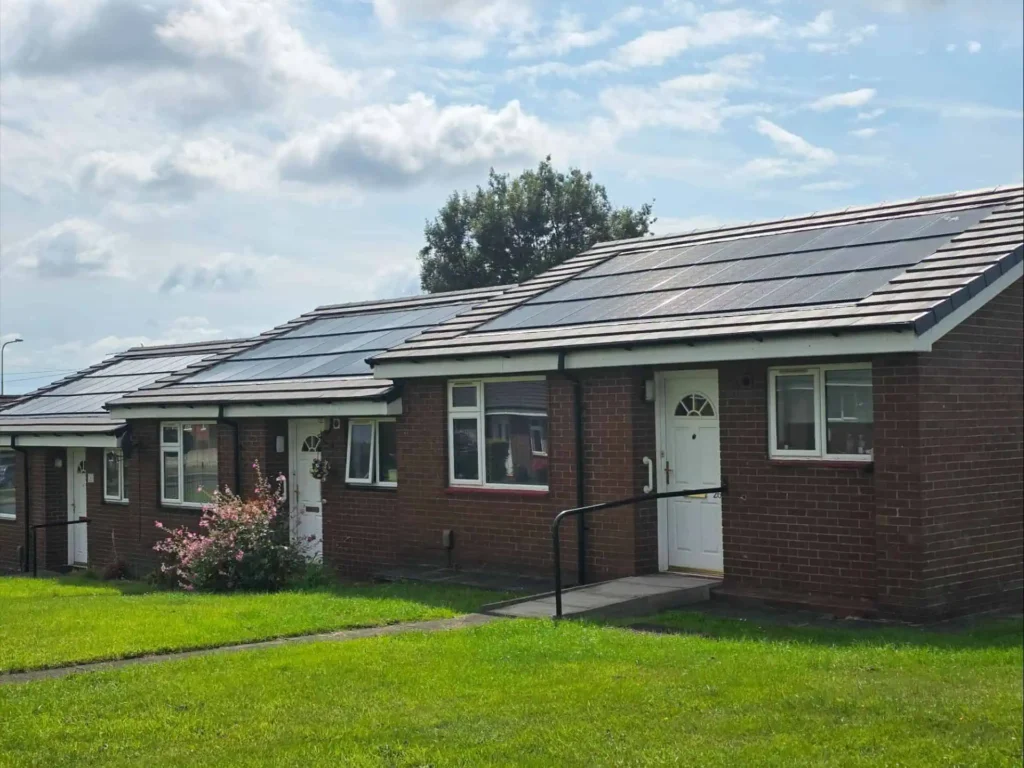 Row of brick bungalows with solar panels on roofs