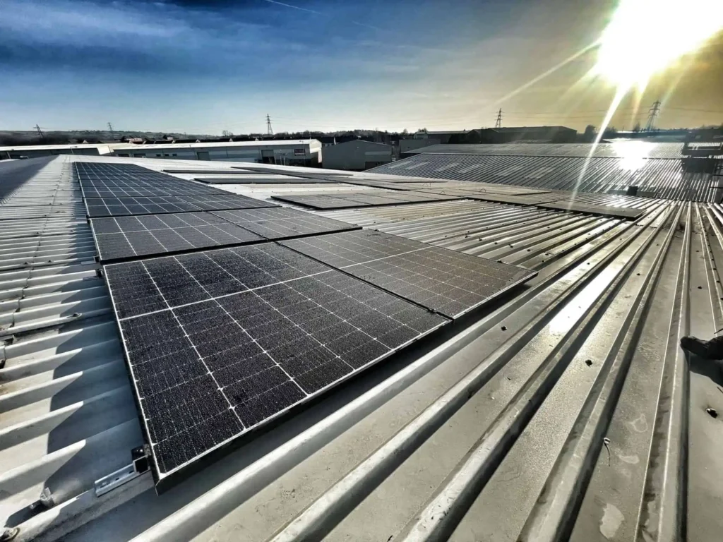 Solar panels installed on industrial building roof with sunlight