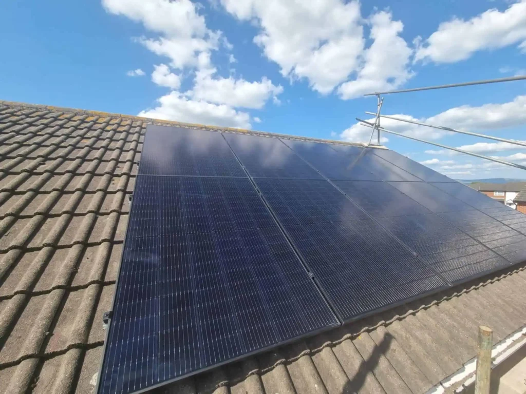Solar panels installed on residential roof with blue sky