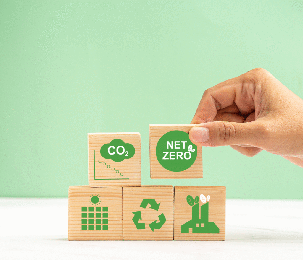 Hand placing wooden block with net zero environmental sustainability icons