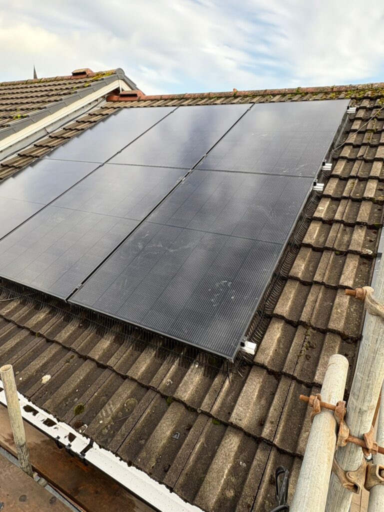 Solar panels installed on residential roof with clay tiles